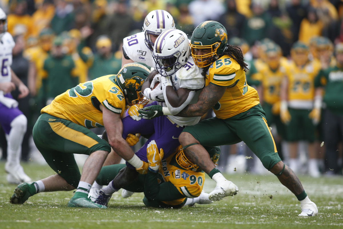 Jan 11, 2020; Frisco, Texas, USA; James Madison Dukes running back Percy Agyei-Obese (31) is tackled by North Dakota State Bison linebacker Aaron Mercadel (55) in the first quarter at Toyota Stadium.